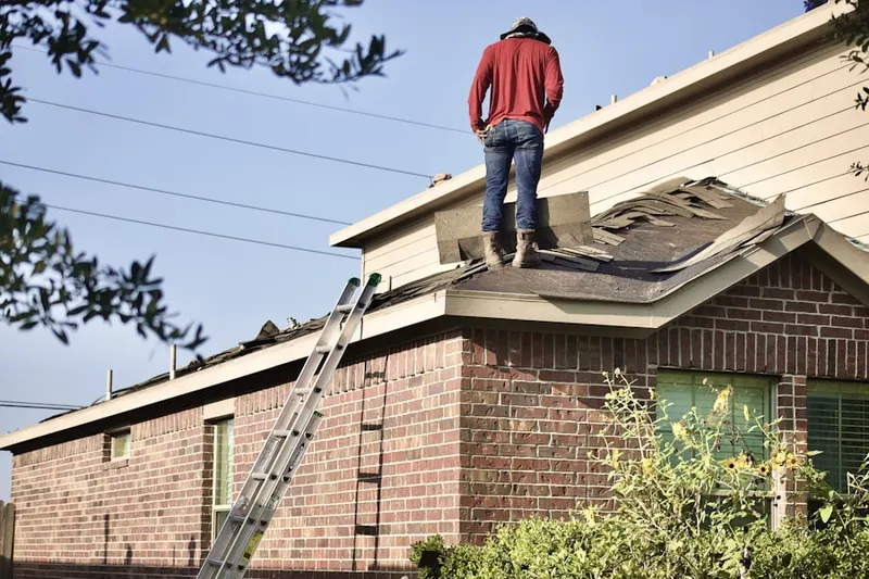 Professional roofer working on a residential roof in Great Bend